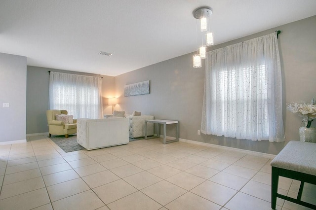 3430 Harlequin Dr, Saint Cloud, FL 34772 - living room featuring light tile patterned floors and baseboards