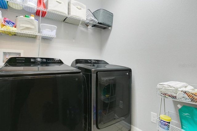3430 Harlequin Dr, Saint Cloud, FL 34772 - laundry area featuring washer and dryer and tile patterned flooring