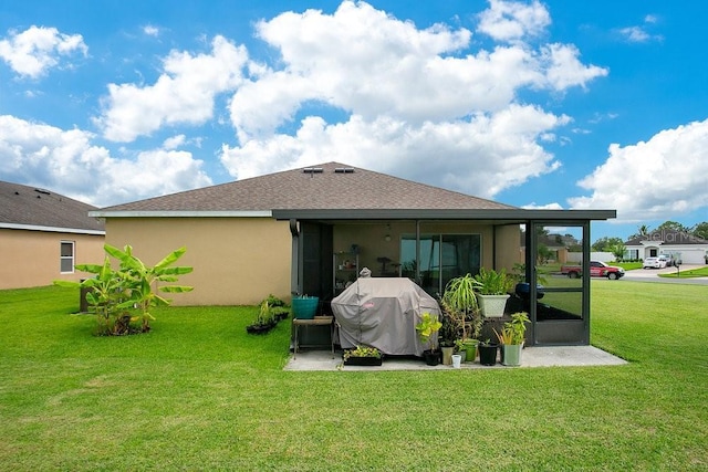 3430 Harlequin Dr, Saint Cloud, FL 34772 - rear view of house featuring a yard, stucco siding, a sunroom, and roof with shingles