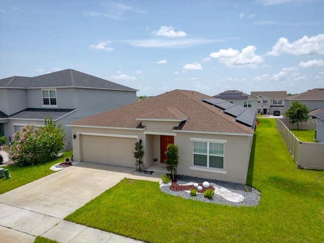588 Meadow Bend Dr, Davenport, FL 33837 - view of front of house featuring an attached garage, stucco siding, concrete driveway, roof mounted solar panels, and a shingled roof