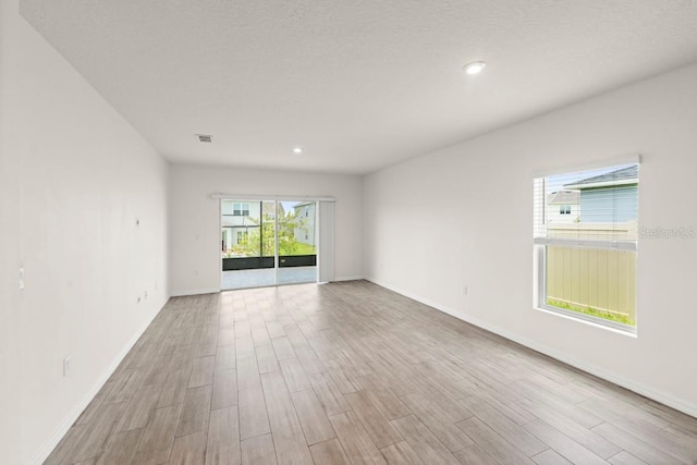 588 Meadow Bend Dr, Davenport, FL 33837 - spare room with wood finished floors and recessed lighting