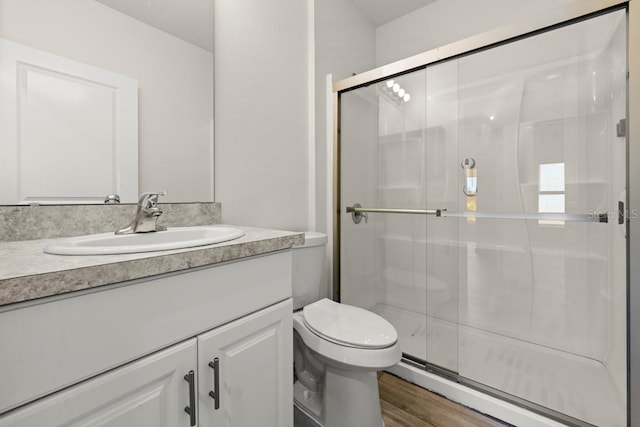 588 Meadow Bend Dr, Davenport, FL 33837 - full bathroom with vanity, a baseboard radiator, a stall shower, and wood finished floors