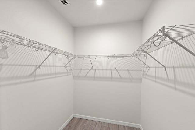 588 Meadow Bend Dr, Davenport, FL 33837 - walk in closet with wood finished floors