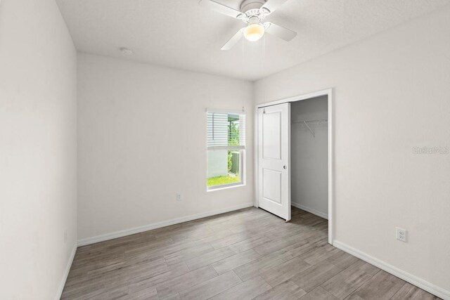 588 Meadow Bend Dr, Davenport, FL 33837 - unfurnished bedroom featuring wood finished floors, a closet, and ceiling fan