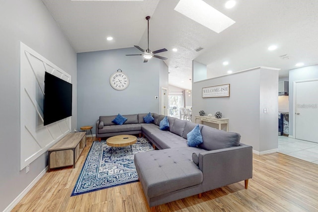120 Bloomingdale Dr, Davenport, FL 33897 - living room with vaulted ceiling, a skylight, light wood-style floors, a ceiling fan, and recessed lighting