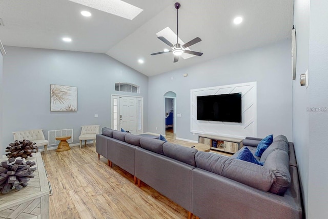 120 Bloomingdale Dr, Davenport, FL 33897 - living area featuring a skylight, vaulted ceiling, light wood-style floors, arched walkways, and ceiling fan
