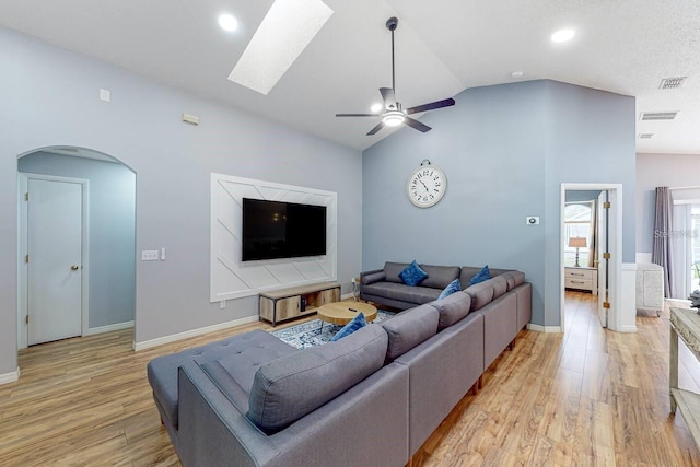 120 Bloomingdale Dr, Davenport, FL 33897 - living area with lofted ceiling, light wood finished floors, a ceiling fan, arched walkways, and a skylight