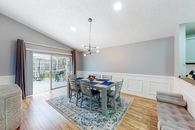 120 Bloomingdale Dr, Davenport, FL 33897 - dining area with a textured ceiling, wainscoting, light wood-style floors, a chandelier, and recessed lighting