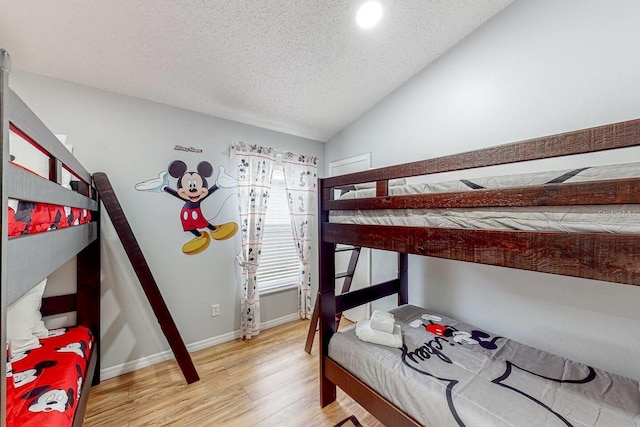 120 Bloomingdale Dr, Davenport, FL 33897 - bedroom with light wood-type flooring, vaulted ceiling, and a textured ceiling