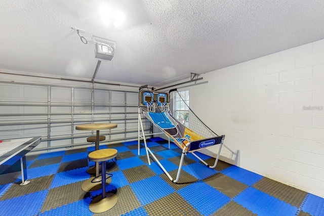 120 Bloomingdale Dr, Davenport, FL 33897 - playroom featuring a textured ceiling, carpet, and concrete block wall