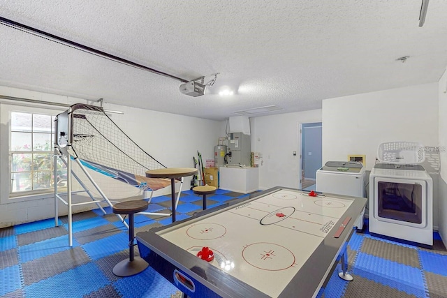 120 Bloomingdale Dr, Davenport, FL 33897 - game room featuring washer and clothes dryer, a textured ceiling, heating unit, and electric water heater