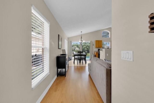 2892 Kokomo Loop, Haines City, FL 33844 - hall with light wood-type flooring, a chandelier, and vaulted ceiling
