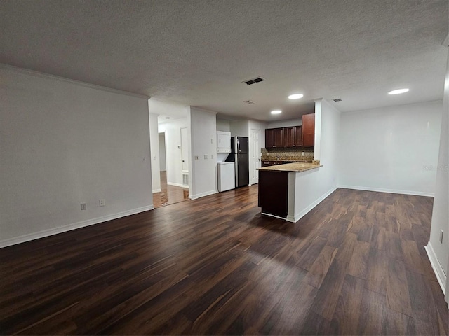 2408 Barley Club Ct Unit 7, Orlando, FL 32837 - kitchen with freestanding refrigerator, open floor plan, dark wood-type flooring, backsplash, and a textured ceiling