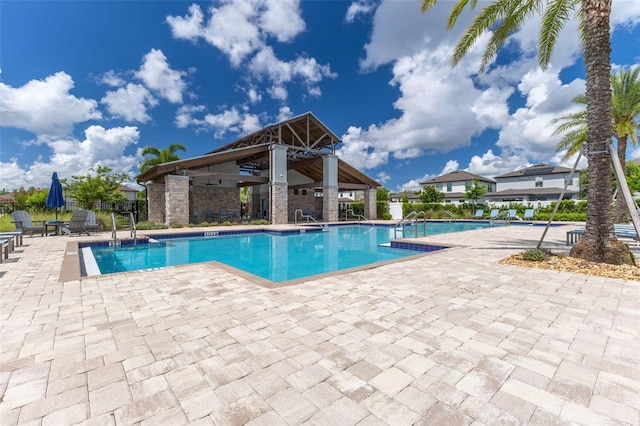 9878 Aurea Moss Ln, Orlando, FL 32832 - community pool with a patio area