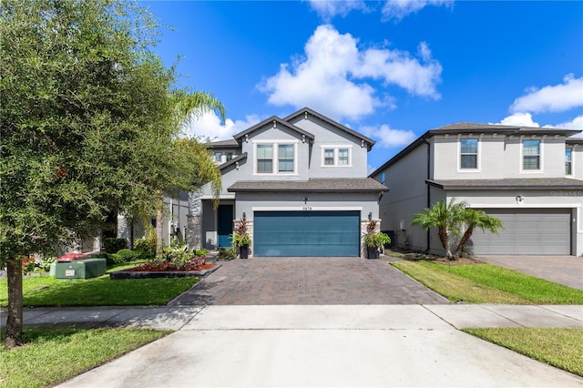 9878 Aurea Moss Ln, Orlando, FL 32832 - view of front of home featuring stucco siding, an attached garage, driveway, and a front yard
