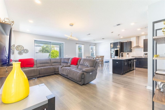 9878 Aurea Moss Ln, Orlando, FL 32832 - living area featuring light wood-type flooring and recessed lighting