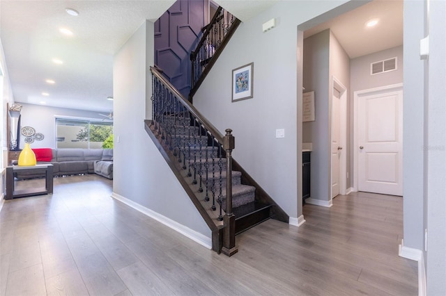 9878 Aurea Moss Ln, Orlando, FL 32832 - stairway featuring wood finished floors, recessed lighting, and a ceiling fan