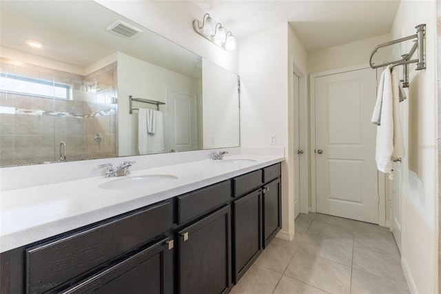 9878 Aurea Moss Ln, Orlando, FL 32832 - bathroom featuring double vanity, a shower stall, and tile patterned flooring