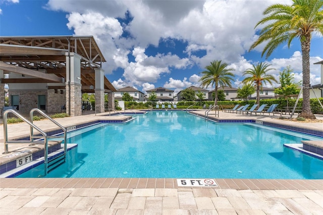 9878 Aurea Moss Ln, Orlando, FL 32832 - community pool featuring a patio