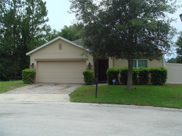 301 Sierra Way, Davenport, FL 33837 - view of front of property with driveway, an attached garage, stucco siding, and a front yard