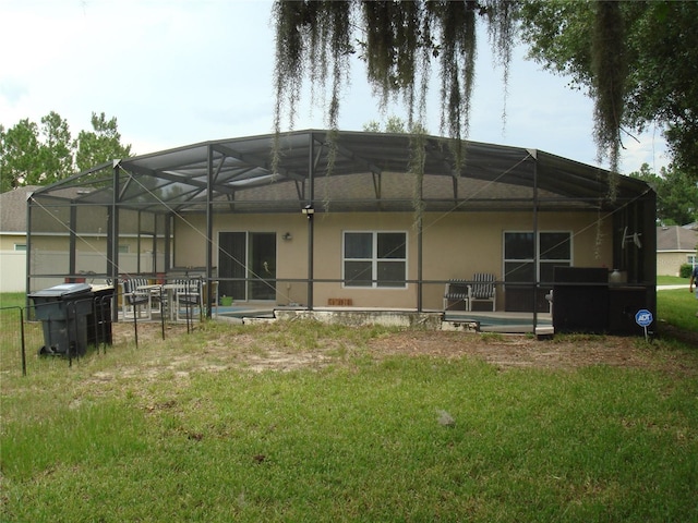 301 Sierra Way, Davenport, FL 33837 - back of house with a lawn, stucco siding, a patio, and a lanai