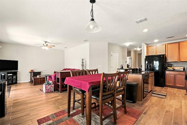 301 Sierra Way, Davenport, FL 33837 - dining room featuring light wood-style floors, a textured ceiling, a ceiling fan, and recessed lighting