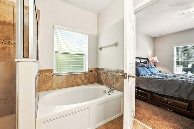 301 Sierra Way, Davenport, FL 33837 - bathroom featuring connected bathroom and a garden tub