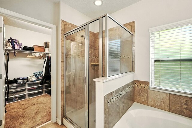 301 Sierra Way, Davenport, FL 33837 - full bath with a shower stall, a bath, a walk in closet, and healthy amount of natural light