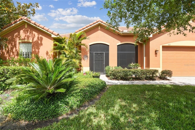 521 Milano Rd, Kissimmee, FL 34759 - mediterranean / spanish home with stucco siding, a tile roof, and an attached garage