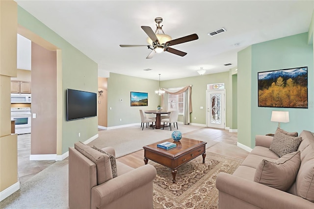 521 Milano Rd, Kissimmee, FL 34759 - living room featuring a ceiling fan and a chandelier