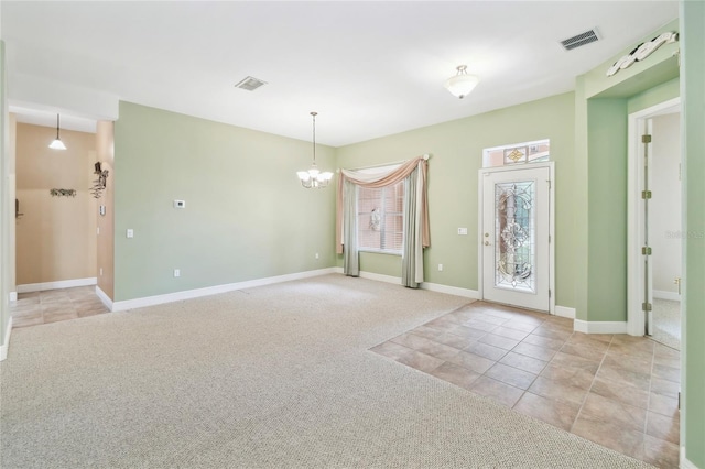 521 Milano Rd, Kissimmee, FL 34759 - empty room featuring a chandelier, light colored carpet, and light tile patterned flooring