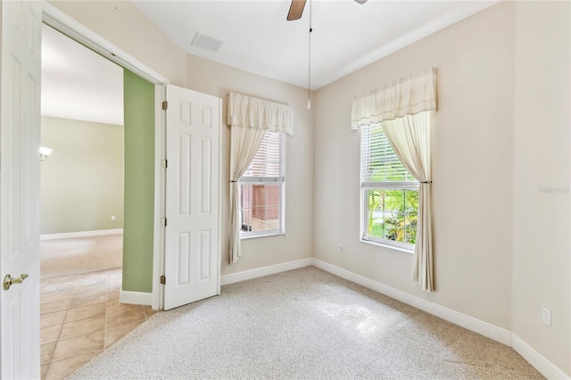 521 Milano Rd, Kissimmee, FL 34759 - carpeted empty room featuring ceiling fan and tile patterned floors