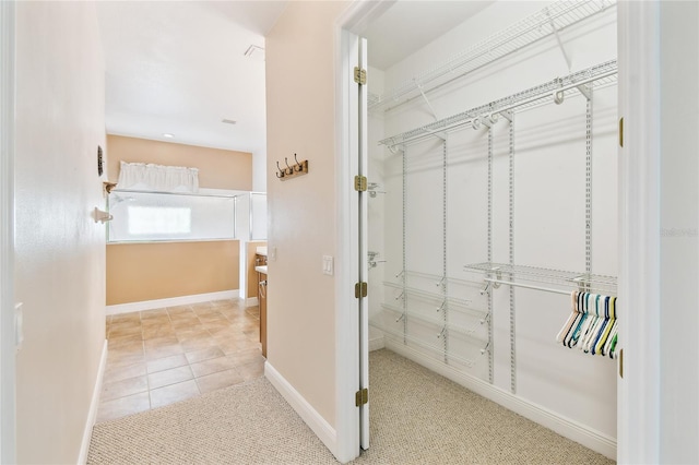 521 Milano Rd, Kissimmee, FL 34759 - walk in closet featuring carpet floors and tile patterned flooring