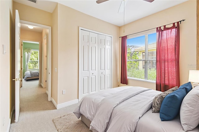 521 Milano Rd, Kissimmee, FL 34759 - bedroom with light carpet, a closet, and a ceiling fan