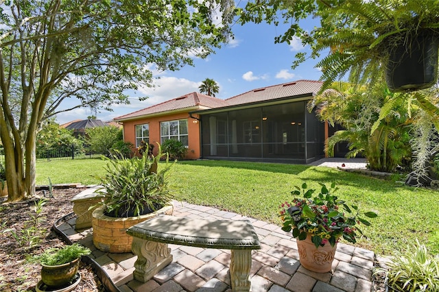 521 Milano Rd, Kissimmee, FL 34759 - view of yard featuring a patio area and a sunroom