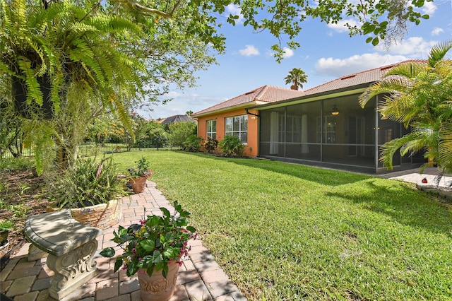 521 Milano Rd, Kissimmee, FL 34759 - view of green lawn with a sunroom and a patio area