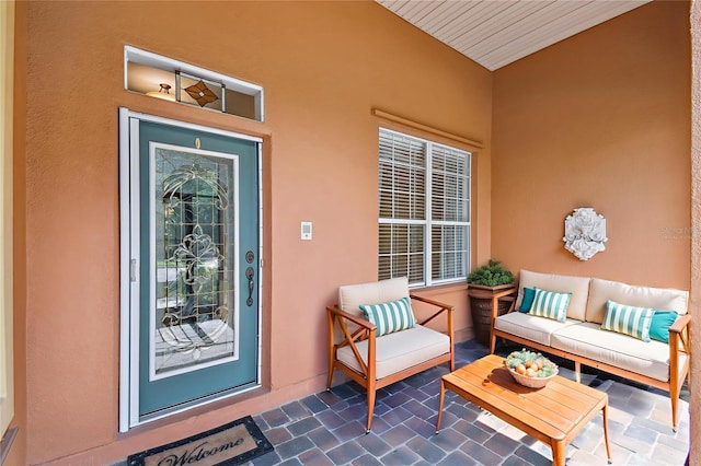 521 Milano Rd, Kissimmee, FL 34759 - view of exterior entry featuring an outdoor living space, stucco siding, and a patio area