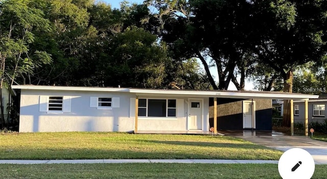 2940 Lake Margaret Dr, Orlando, FL 32806 - ranch-style house featuring stucco siding, an attached carport, and a front lawn