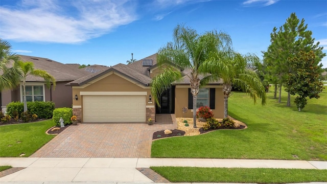 802 Soria Ln, Davenport, FL 33837 - single story home with an attached garage, decorative driveway, stucco siding, a front lawn, and stone siding