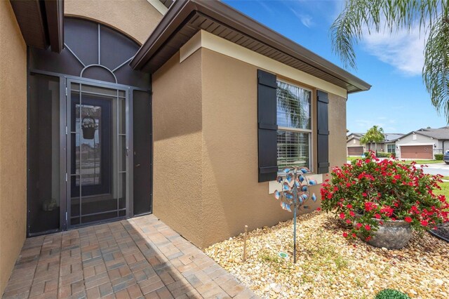 802 Soria Ln, Davenport, FL 33837 - doorway to property with stucco siding