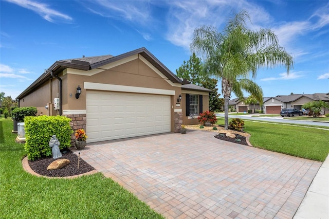 802 Soria Ln, Davenport, FL 33837 - ranch-style house with stone siding, a front lawn, a garage, stucco siding, and decorative driveway