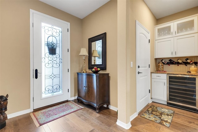 802 Soria Ln, Davenport, FL 33837 - entryway featuring wine cooler, a dry bar, and light wood finished floors