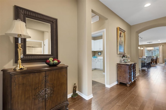 802 Soria Ln, Davenport, FL 33837 - hallway with arched walkways, dark wood-type flooring, a chandelier, and recessed lighting