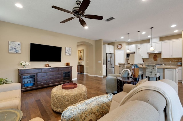 802 Soria Ln, Davenport, FL 33837 - living room with arched walkways, dark wood finished floors, ceiling fan, and recessed lighting