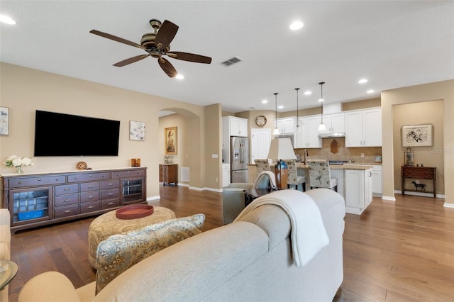 802 Soria Ln, Davenport, FL 33837 - living area with arched walkways, ceiling fan, wood finished floors, and recessed lighting