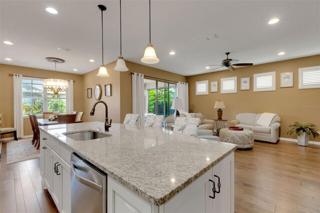802 Soria Ln, Davenport, FL 33837 - kitchen with stainless steel dishwasher, light wood-style flooring, plenty of natural light, and recessed lighting