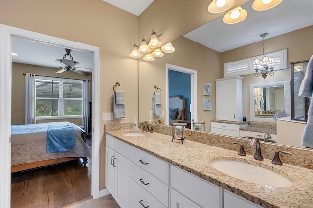 802 Soria Ln, Davenport, FL 33837 - bathroom featuring ensuite bathroom, double vanity, wood finished floors, and a chandelier