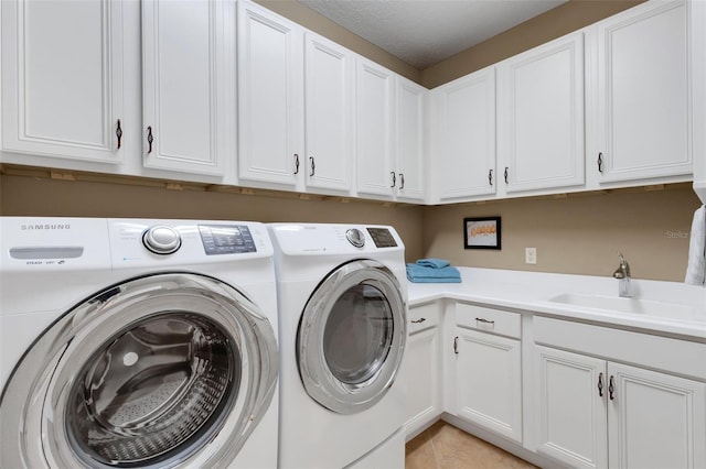 802 Soria Ln, Davenport, FL 33837 - laundry area featuring washing machine and dryer, cabinet space, and light tile patterned floors