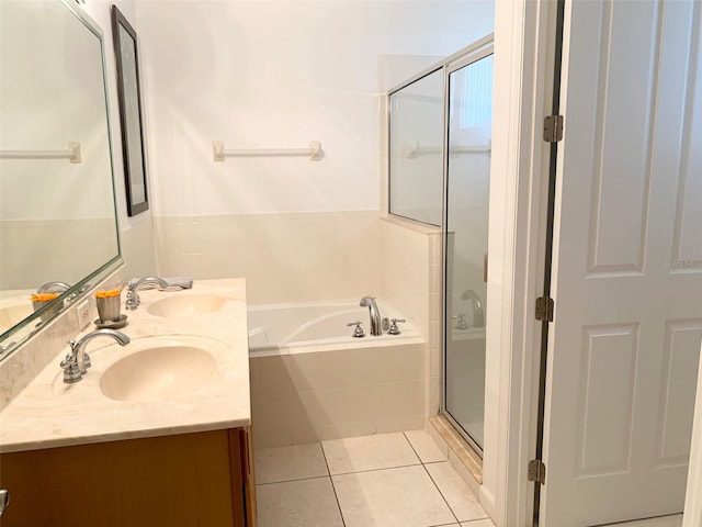 352 Cherokee Ave, Haines City, FL 33844 - bathroom with a bath, double vanity, tile patterned flooring, and a shower stall