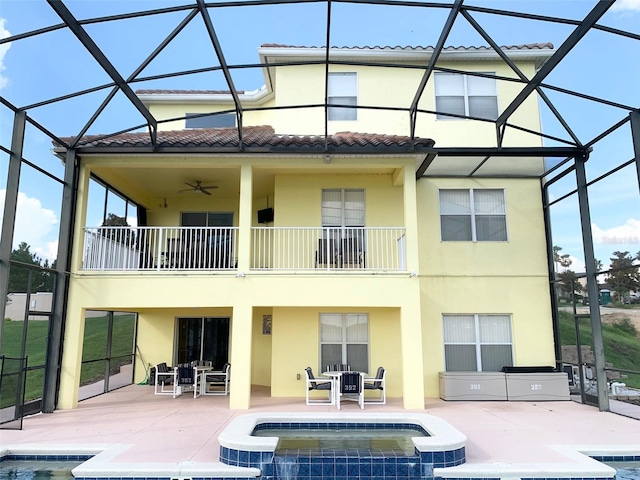 352 Cherokee Ave, Haines City, FL 33844 - rear view of house with a balcony, stucco siding, a patio area, a lanai, and a tile roof